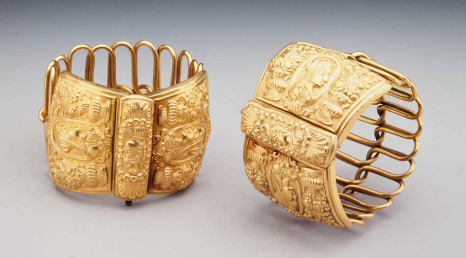 Pair of wide gold bracelets with relief portraits and flowers